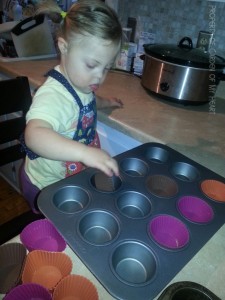Making cupcakes - placing liners.