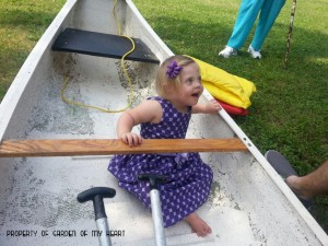 Rowenna in her flower girl dress, enjoying a canoe. 